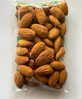 Packaged almonds in a clear plastic bag on a white background