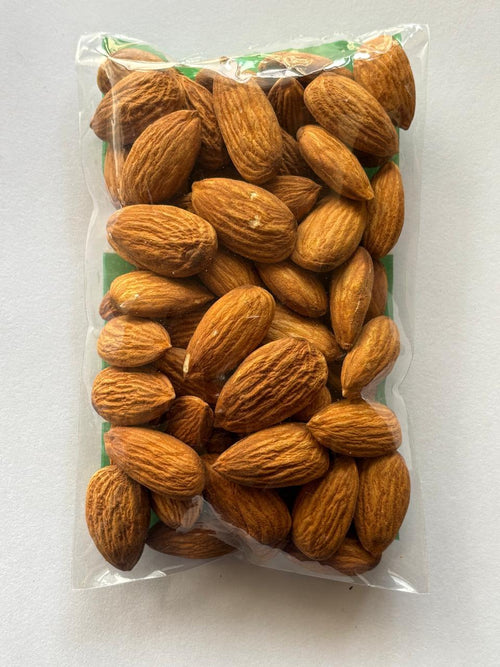 Packaged almonds in a clear plastic bag on a white background