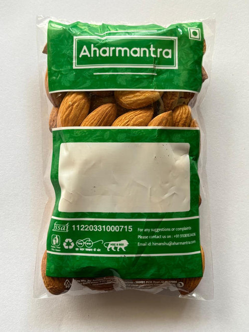 Bag of almonds with Aharmantra branding on a white background