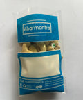 Aharmantra packaging with cashew inside on a white background