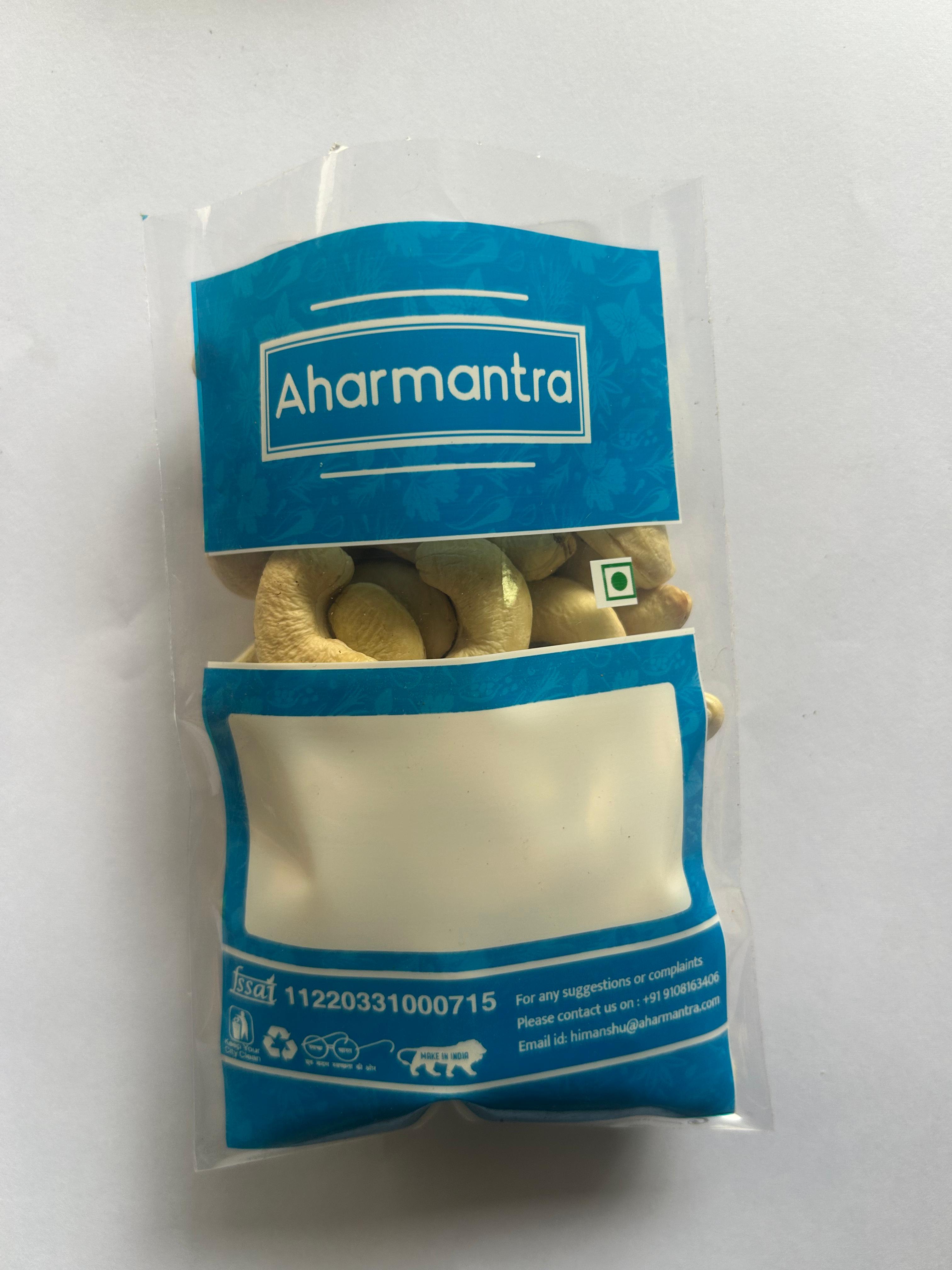 Aharmantra packaging with cashew inside on a white background